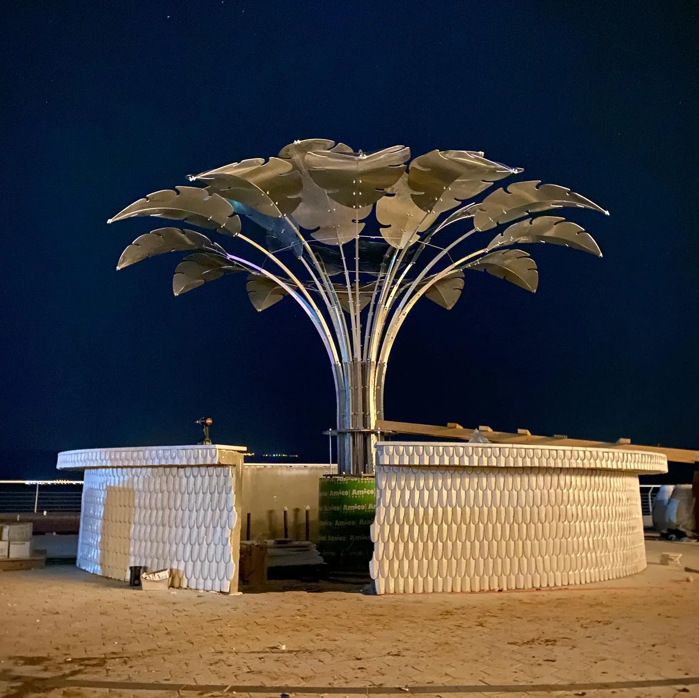 The full crown at night, frontal — a builder's drill still resting on the counter.