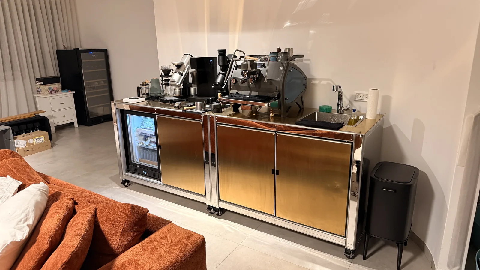 Cube Coffee installed along a wall, machines on the counter and the glass fridge lit blue.