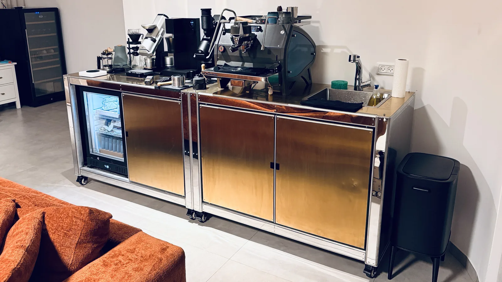 Espresso machine and grinders standing on Cube Coffee copper counter.