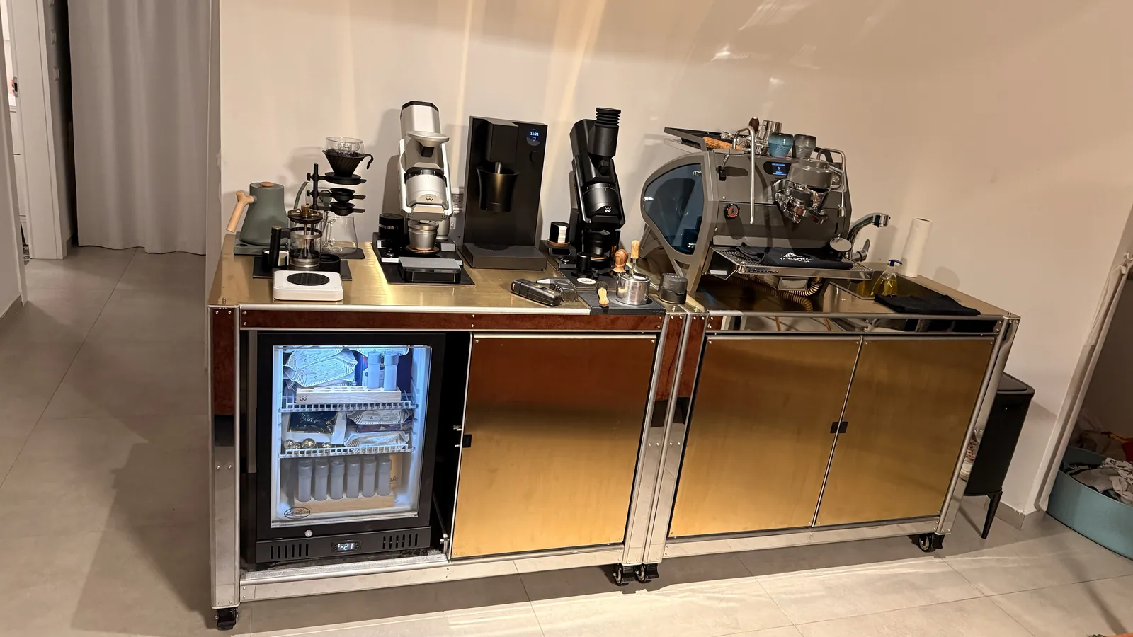 Cube Coffee seen at an angle from the far end, grinder in the foreground.