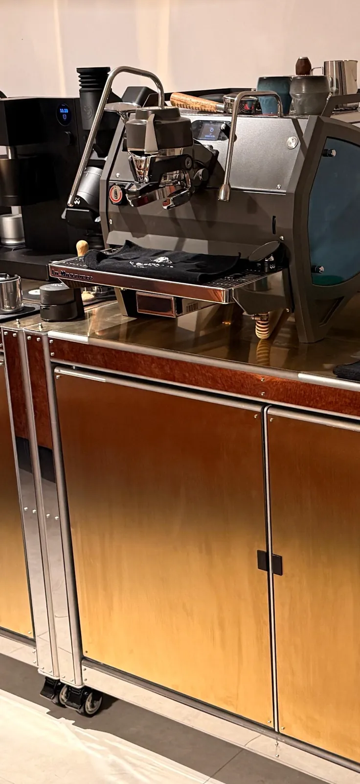 Close view of the espresso machine on Cube Coffee, copper door below.