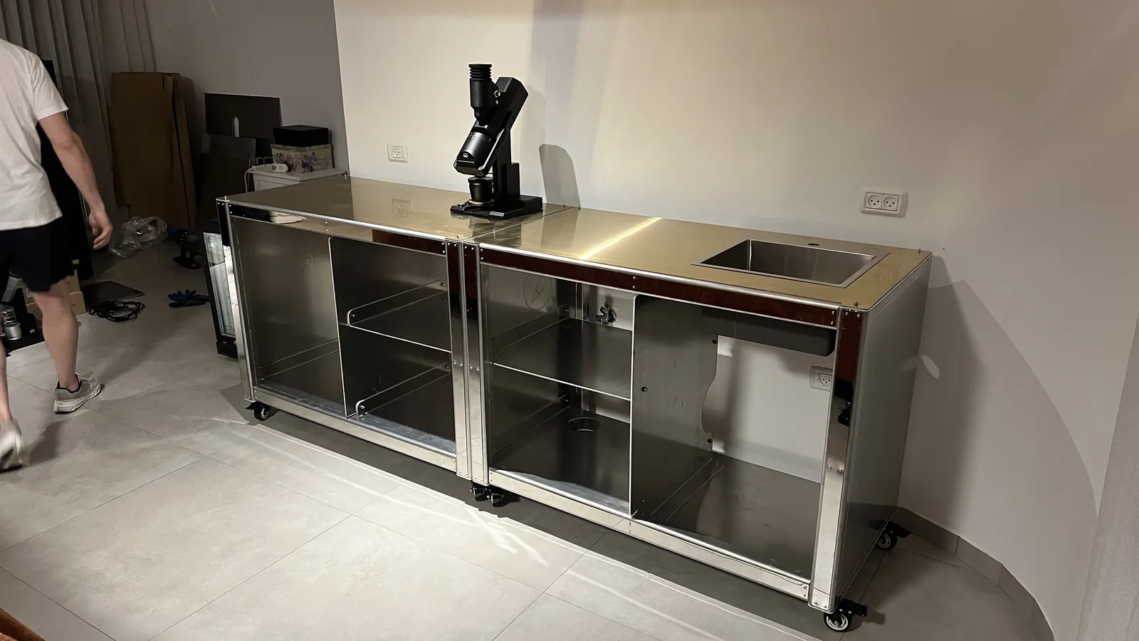 The bare stainless frame of Cube Coffee standing in the room before cladding.