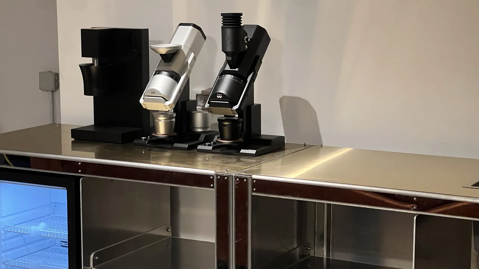 The Cube Coffee counter with the first machine set on it, display glowing below.
