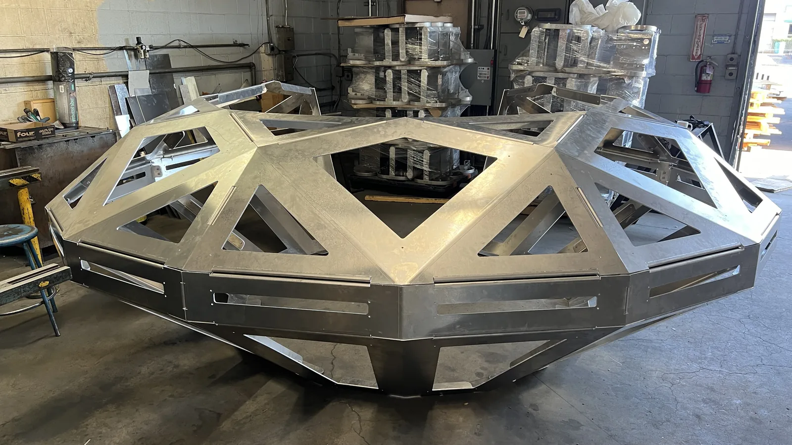 The Diamond UFO's frame assembled in raw mill-finish aluminium, triangulated cutouts through every facet, 16 August 2023.