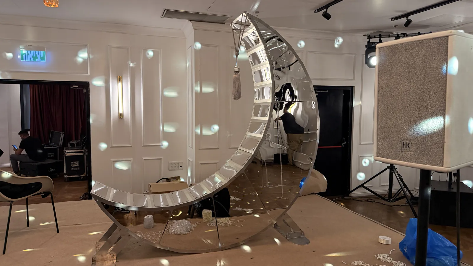Moon Chair installed at a private event, mirror faces carrying the room light.