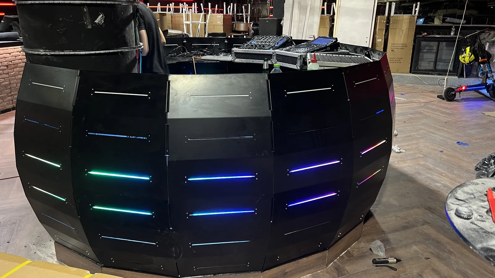 Octa Dec 18 installed in a club — the faceted horseshoe with its LED seams running multicolor, first deck on the surface.