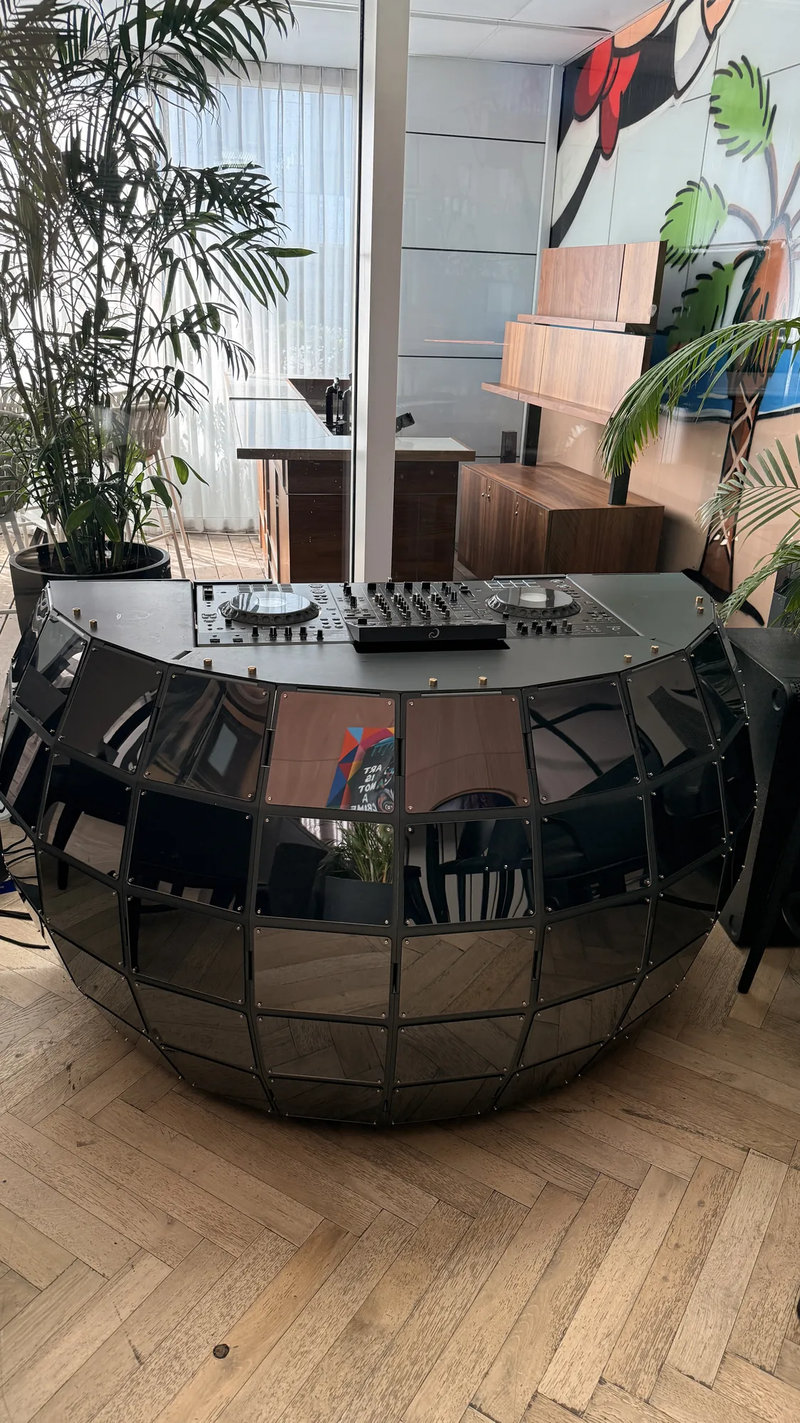 Quad Sphere real-room photo showing the curved shell in context.