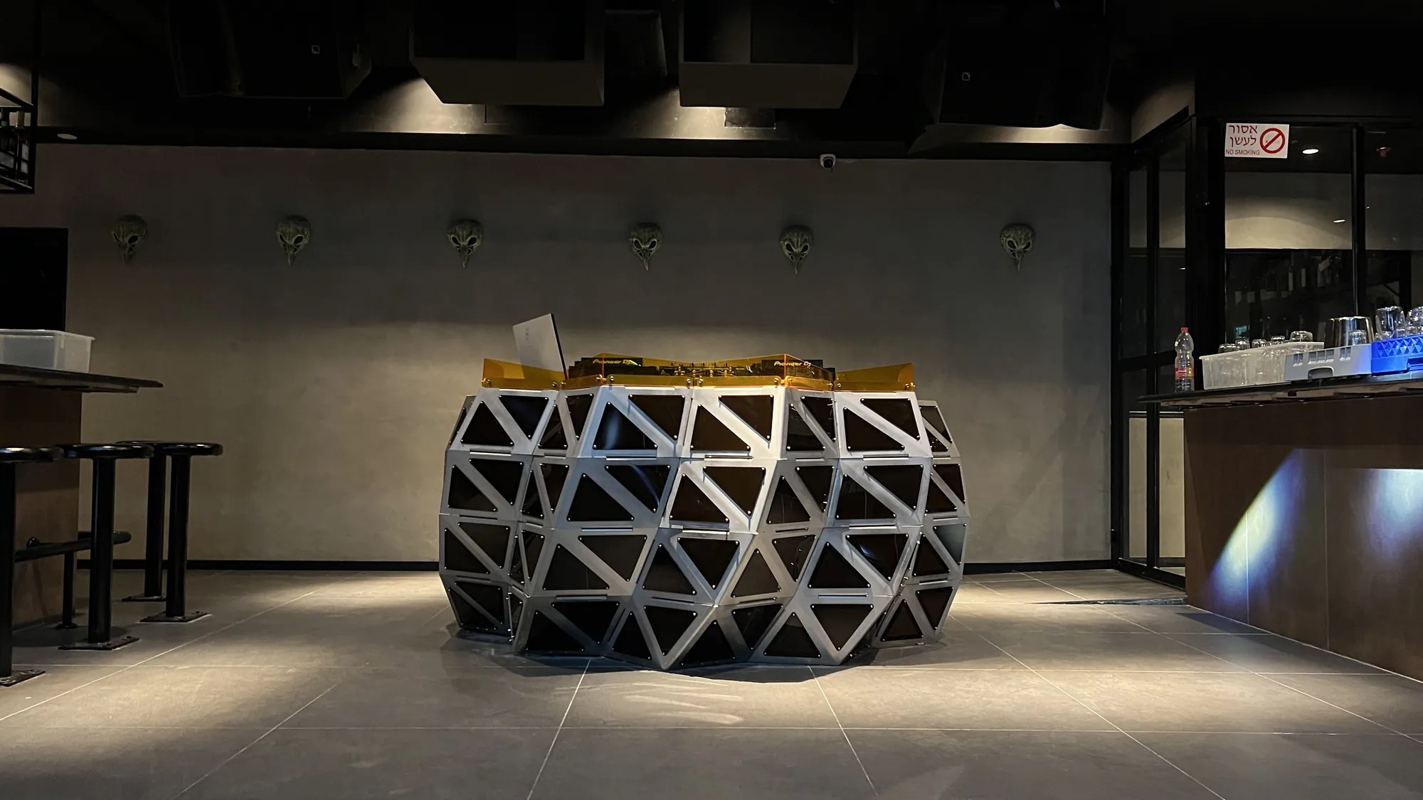 Twisted Star — a faceted steel booth, smoked panels between the ribs.